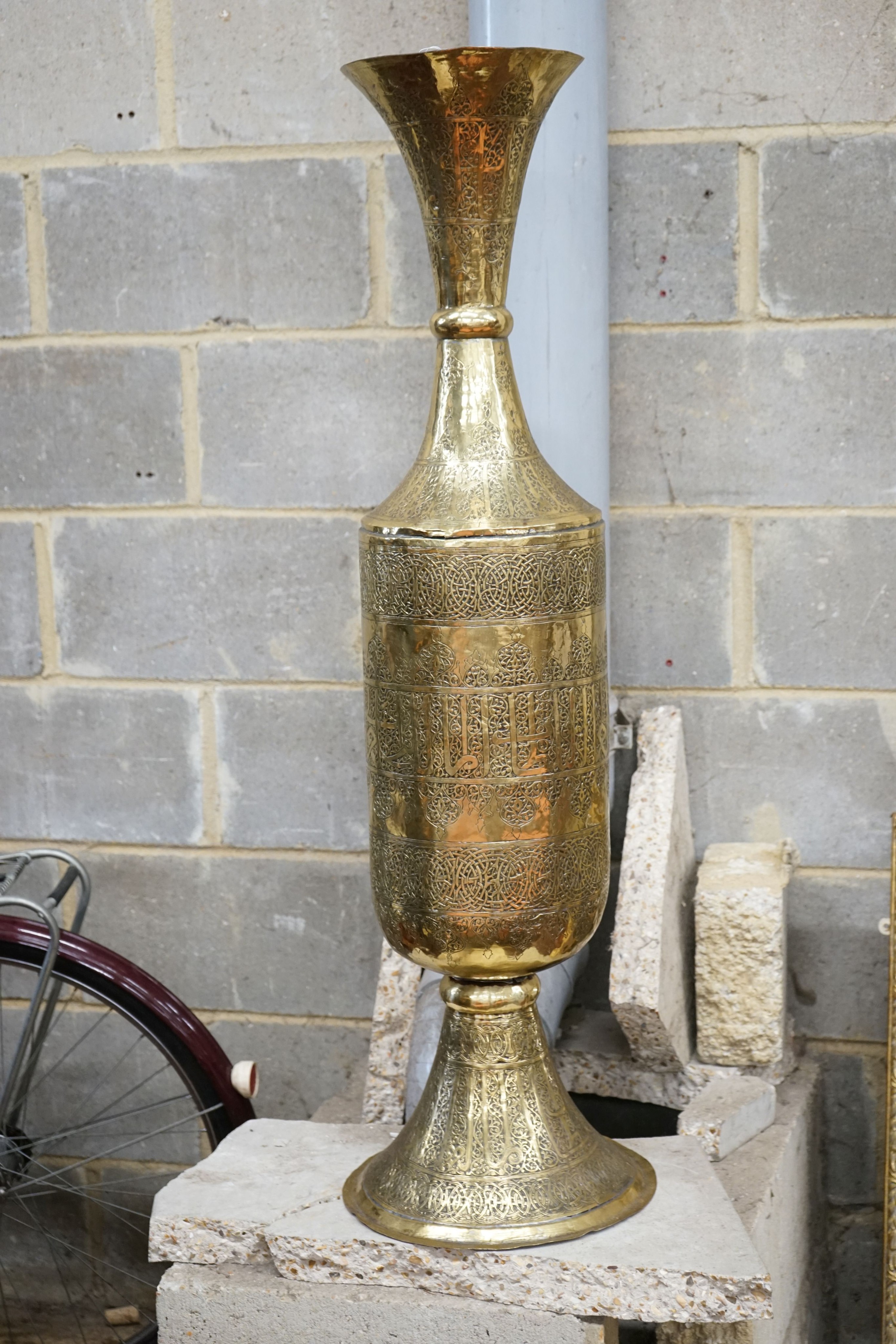 A large Syrian embossed brass floor vase, height 113cm